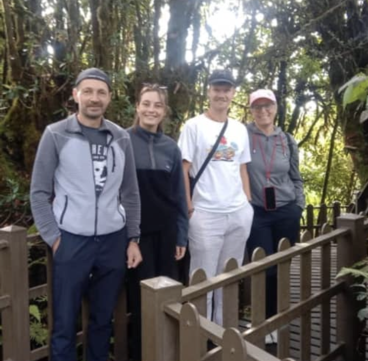 Tourist group at mossy forest walkway