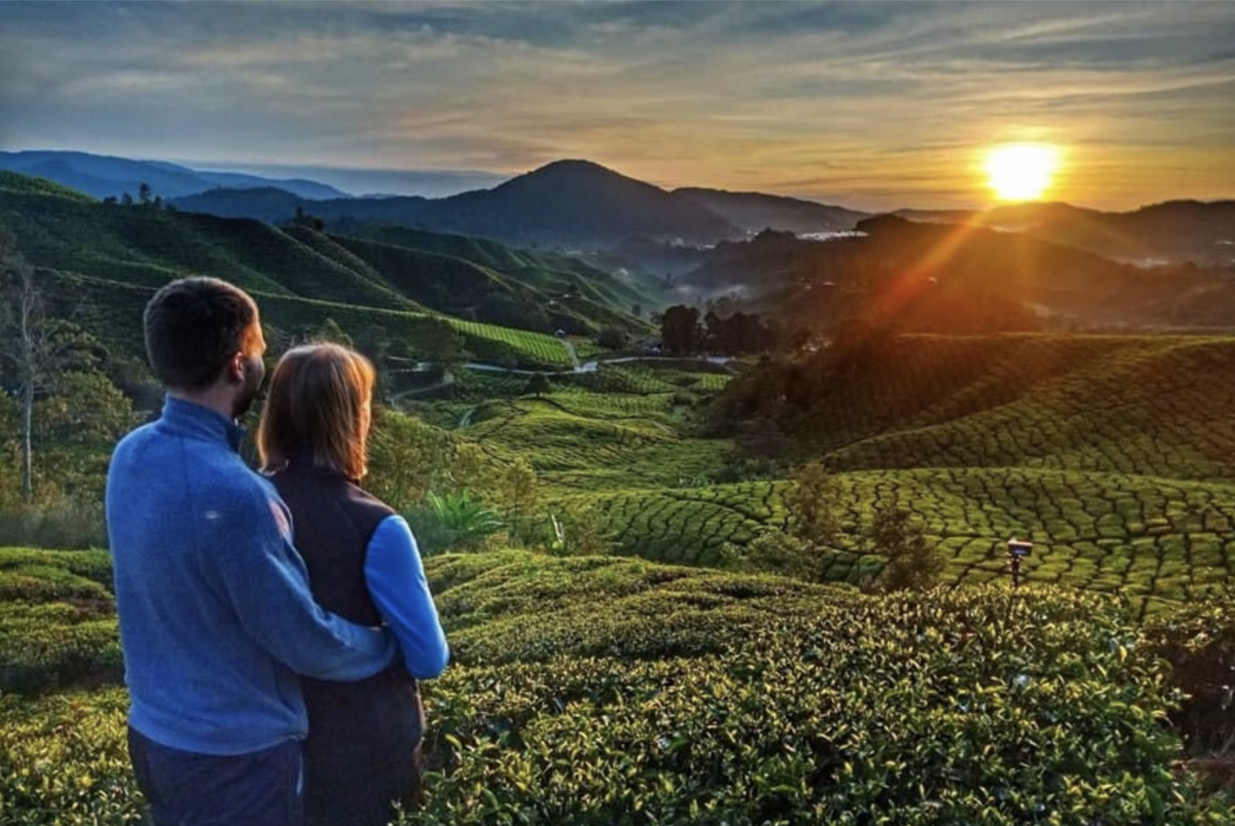 Couple watching sunset over tea hills